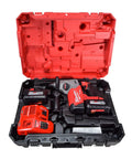 One Inch Sds Plus Brushless Rotary Hammer Cordless Kit Featuring Dual Six Ah Batteries And Fast Charger in red case.