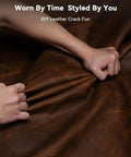 Hands gripping a dark brown leather material, showcasing its flexibility and texture for DIY Leather Crack Fun applications.