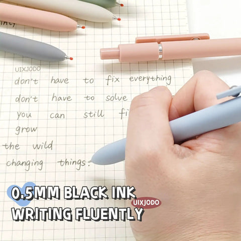 Five Pack Gel Pens 0.5mm Fine Point Black Ink With Super Soft Grip writing on paper, Morandi color set pens shown.