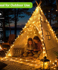 Outdoor Solar String Lights With 100 LEDs 33 Feet 8 Modes Weatherproof Fairy Lights illuminating a tent in a cozy backyard setting.