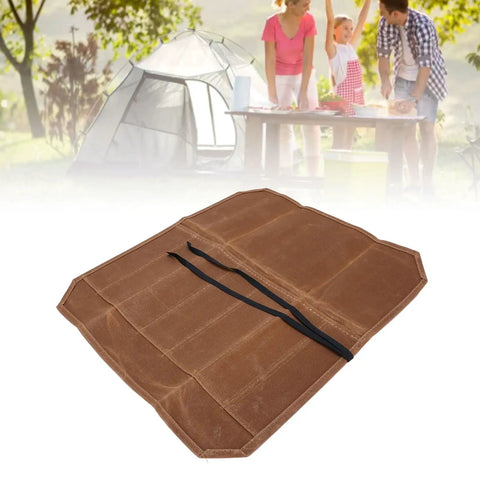 Seven Slot Waxed Canvas Chef Knife Roll Bag for Outdoor Camping and Travel in open flat position near family cooking scene