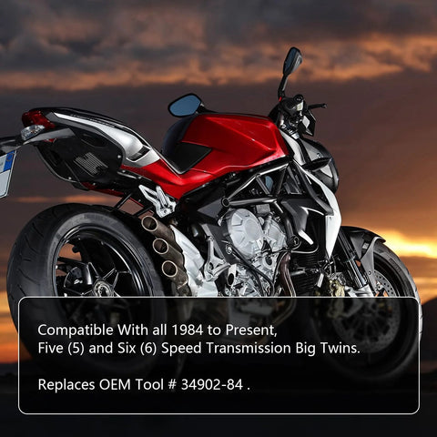 Motorcycle with red body, black frame, and exposed engine at sunset.