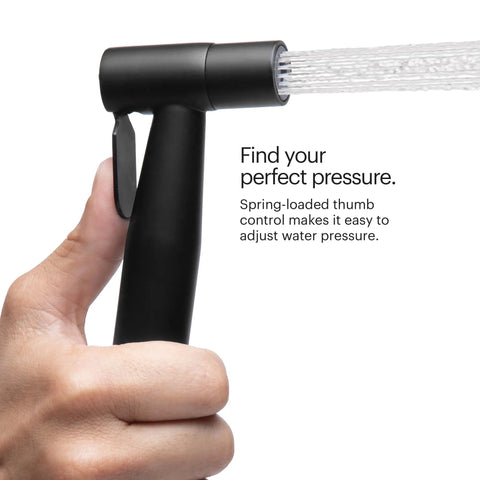 Person holding Matte Black Stainless Steel Handheld Bidet Sprayer Kit With Dual Spray Options showing water stream.