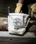Close-up of small tool pouch for bolt storage with bull pin loops and belt clip, made in durable No. 4 canvas, on workbench.