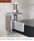 Front view of stainless steel mini C-clamp (1 inch) with protective pad clamping onto a desk edge.