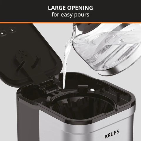 Compact Five Cup Coffee Maker With Stainless Steel Design And Pause And Brew Function Keep Warm Reusable Filter Drip Free Carafe Perfect For Small Kitchens Or Offices" with open lid and water being poured in.