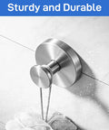 Heavy Duty Black Suction Cup Hooks Two Pack No Drill Bathroom Wall Adhesive Rack For Towels Robes And Fitness Gear Featuring Hella Strong Silicone Base That Snags Tight On Glass Or Tile With Zero Hassle, showing stainless steel hook holding a loofah.