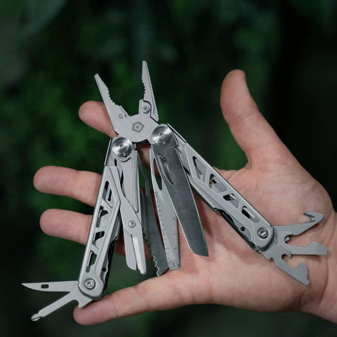 Hand holding 13 In 1 Stainless Steel EDC Multitool With Nylon Sheath for Camping, Hiking, and Fishing, showing tools extended.