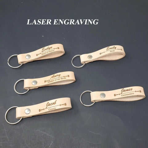 Five engraved one half inch natural vegetable tanned leather keychain blanks, personalized for wedding roles.