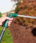 Industrial Spray Nozzle With Quick Connect Set Pro Grade Adjustable Pattern From Gentle Rinse To Powerful Jet Durable Rubberized Grip And Metal Trigger For All Purpose Lawn Watering Threaded Tip Attachments Plus Protective Cover Included being used in a garden