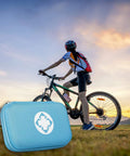 Cyclist with Survival First Aid Kit 273 Piece Emergency Medical Supplies Set In Blue for outdoor adventures