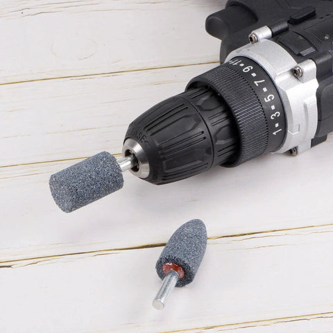 Pro Grade Fifteen Piece Abrasive Mounted Stones Set With One Quarter Inch Shank And One Inch Cylindrical Corundum Grinding Heads shown on a drill