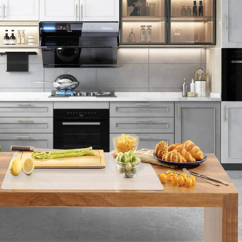Hella Large Heat Resistant Silicone Counter Protector on a kitchen countertop with fresh ingredients and baked goods.