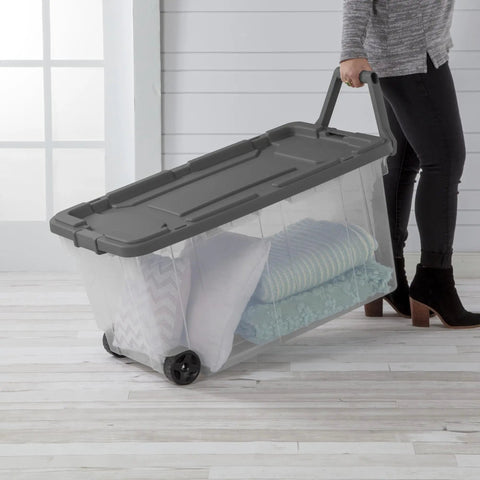 Person using 4 Pack Modular Stacker Box Set Of Durable Clear Plastic Storage Bins With Latching Lids 160 Quart Capacity