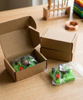 Open box showing green DC Electrical Motor Assembly Kit for STEM Learning Hands On Kids Lab Toy on a wooden table.