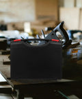 Badass Low Profile Plastic Toolbox With Tight Fitting Lid And Ergonomic Handle For All Your Bolts and Art Pieces Clean Layout Storage on a workbench.