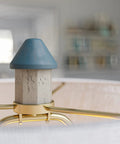 Close-up of Coastal Nantucket Table Lamp in Antique White Finish, 31 Inch Tall lighthouse-inspired detail with blue top.