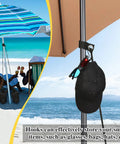 Beach umbrella with 2 Pack Large Beach Umbrella Sand Bags Heavy Duty Waterproof Counterweights and S Hooks on stand at the beach