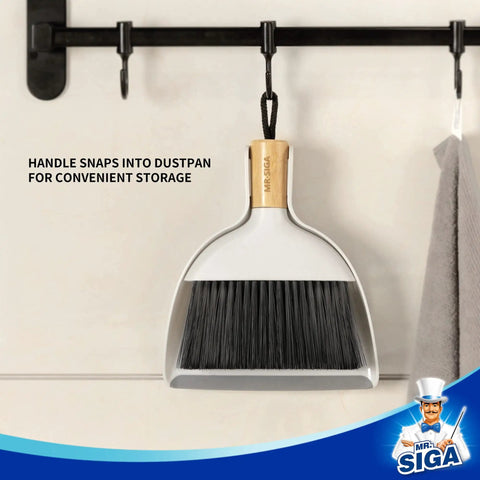 Grab And Go Mini Dustpan And Brush Set With Bamboo Handle hanging on hook, dense soft bristles visible, white dustpan.