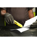 Person using Basic Snap Off Blade Knife, 18 Millimeter Utility Cutter For Light Duty Cutting on paper, gloved hand visible