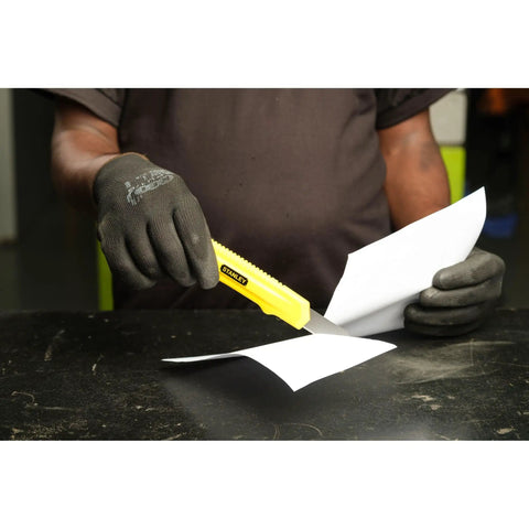 Person using Basic Snap Off Blade Knife, 18 Millimeter Utility Cutter For Light Duty Cutting on paper, gloved hand visible