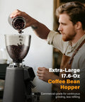 Barista pouring beans into 64mm Burr Coffee Grinder For Home Barista Use With Commercial Grade Precision And 100 Grind Settings