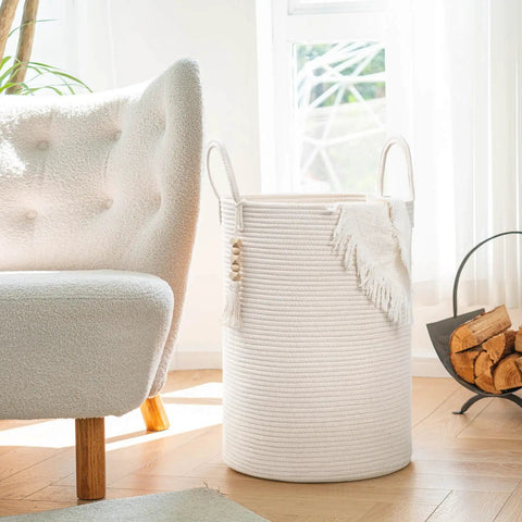 White Laundry Basket With Handles, Tall Woven Hamper For Clothes And Towels, Holds A Week Of Laundry next to sofa, 16x20 inches