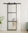 Clear Tempered Glass Barn Door 28 Inch By 84 Inch With Carbon Steel Frame Pre Drilled For Easy Assembly Including 5 Foot Hardware Kit And Soft Close System For Smooth Sliding And Modern Interior Spaces installed in living room