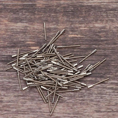 Heavy Duty Watch Stem Extender Built To Last From High Hardness Metal For Precise Winding And Repair Durable Silver Extension Bar For Watchmakers And DIY Self Repair 0.7mm Size 100 scattered on wooden background.