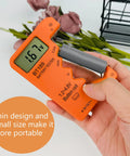 Universal Battery Tester With Digital Display For AA AAA C D 9V 1.5V Batteries Portable Travel Ready Volt Checker For All Battery Types With Clear LCD Readout And Quick Battery Health Gauge Orange Color compact ABS tester in hand with AA battery