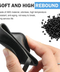 Hand holding Tesla EV Charger Port Cover Waterproof Soft Silicone Dust Cap, black, soft texture, next to black granules.