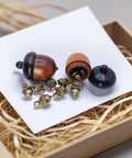Hella Slick Screw Open Miniature Black Ebony Acorn Curios Set Of Two With Hidden Antique Bronze Pinecones, showing open acorns and pinecones.