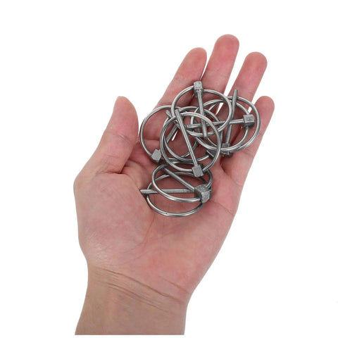 Hand holding Eight Piece Stainless Steel Lynch Pin Assortment Kit With Round Safety Catch Lock Pins For Trailer Hitches Garden Tools And Lawn Mowers Burr Free Finish And Easy Installation