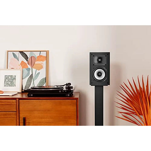 XT15 Monitor Bookshelf and Surround Sound Speakers Pair with Hi Res Audio Certified in a living room setting on a stand