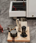 Espresso Tamper Base And Accessories Organizer In Natural Walnut All Size Portafilter Compatible Tamping Station Holder 4-In-One Coffee Bar Setup Perfect For Home Barista Use And Small Coffee Shops, with tools on counter.
