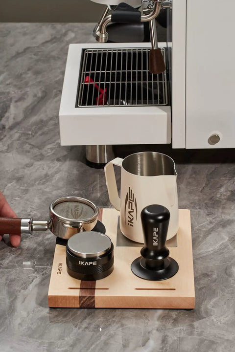 Espresso Tamper Base And Accessories Organizer In Natural Walnut All Size Portafilter Compatible Tamping Station Holder 4-In-One Coffee Bar Setup Perfect For Home Barista Use And Small Coffee Shops, with tools on counter.