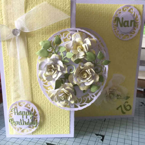 Yellow handmade card with 3D floral frame, greenery, and 'Happy Birthday Nan 76' text created using metal die cuts and embossing dies.