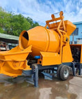 Hardcore Automatic Concrete Mixer Pump With Dead Simple PLC Controls And High Volume Grout Delivery For Foolproof Foundation Pouring and Zero Hassle Job Site Setup, side view showing mixing drum and discharge chute.