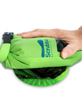 Hand holding a green Pocket Friendly Travel Laundry Sack With A Built In Washboard Surface for scrubbing laundry