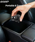Hand holding Badass J1772 To Tesla Charging Adapter With 80 Amp Fast Plug Capability, ready for storage in car console.