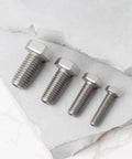 Pro Grade 4 Piece Heavy Duty Stainless Steel Busted Stud Drill Guide Kit M6 M8 M10 M12 with four stainless bolts on stone.