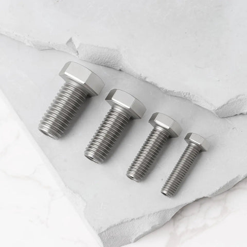 Pro Grade 4 Piece Heavy Duty Stainless Steel Busted Stud Drill Guide Kit M6 M8 M10 M12 with four stainless bolts on stone.