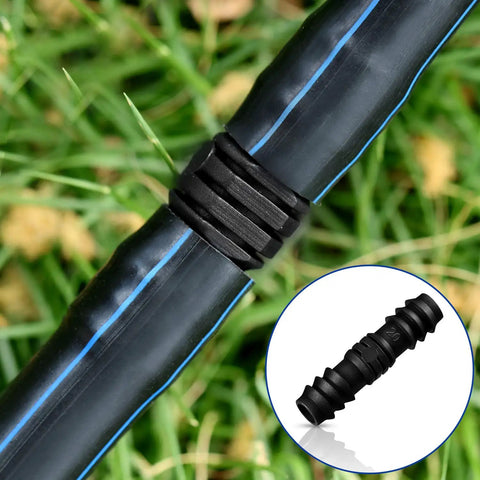 Close-up of barbed connector from All In One 32 Piece Drip Irrigation Fittings Kit For Three Quarter Inch Tubing in use on grass