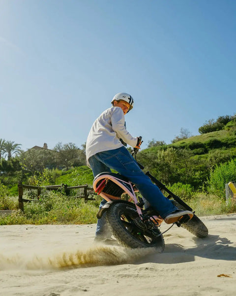 Adult Electric Bike With 1000W Brushless Motor 20Mph Peak Pulls 16Inch Slick Wheels Built To Chomp Potholes And Weave Through Traffic Like A Pro For Chill City Rides in action on sandy terrain.