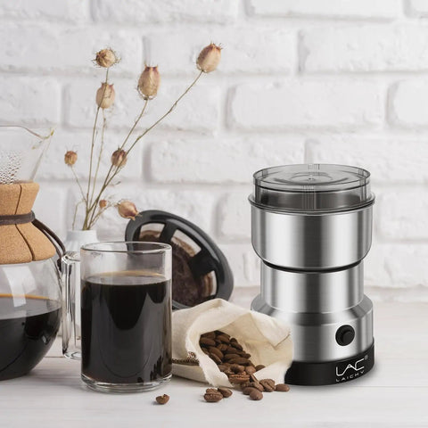 Electric Coffee And Spice Grinder Handheld 150W Quick Grinding With Stainless Steel Blades next to coffee beans and cup