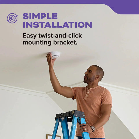 Man installing Hardwired Smoke And Carbon Monoxide Alarm With Voice Alerts, 10 Year Sealed Battery Backup on ceiling