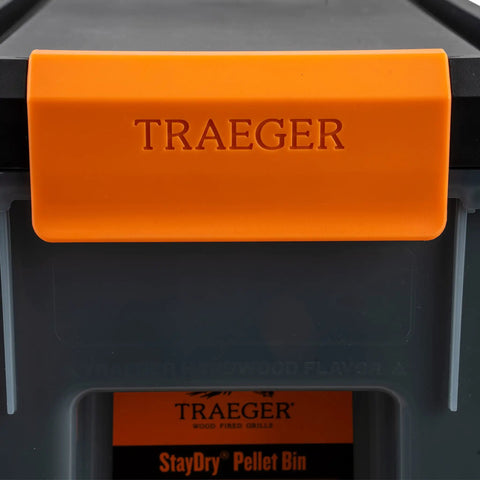 Level Up Your Smoke Game With This Heavy Duty Pellet Storage Bin Featuring A Rugged Locking Lid And Smart Stackable Design To Keep Wood Chips Bone Dry For Peak Grilling Days, showing the orange TRAEGER lid.
