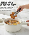 All In One Electric Hot Pot With Steamer And Lid 1.5L Nonstick Ceramic Cooker frying chicken wings in kitchen