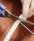Close-up of hands cutting the Battery Powered LED Strip Lights Kit With Remote, 6.56 Feet Long, Cuttable And Easy To Install, 2 Pack