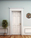 Round 8in aluminum music room wall sign with turntable design mounted on a light blue wall beside a white paneled door